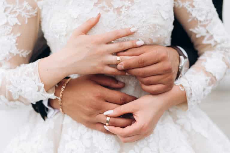 Das Brautpaar tauscht Ringe aus - Die Hände von Bräutigam und Braut im Blickpunkt